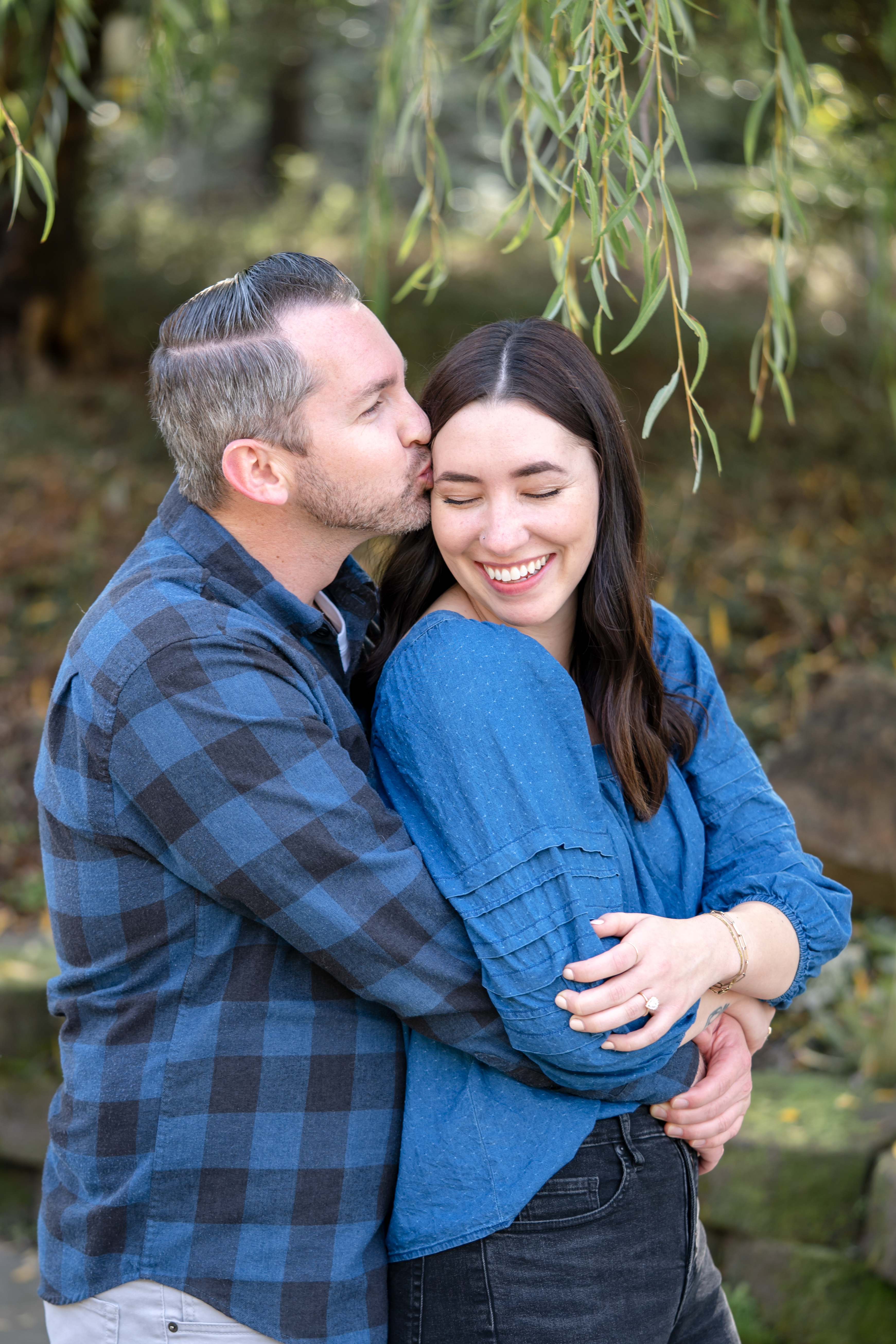 Beautiful Places to Propose in Sonoma California - Auburn James Winery. Man behind woman kissing her head after a proposal.