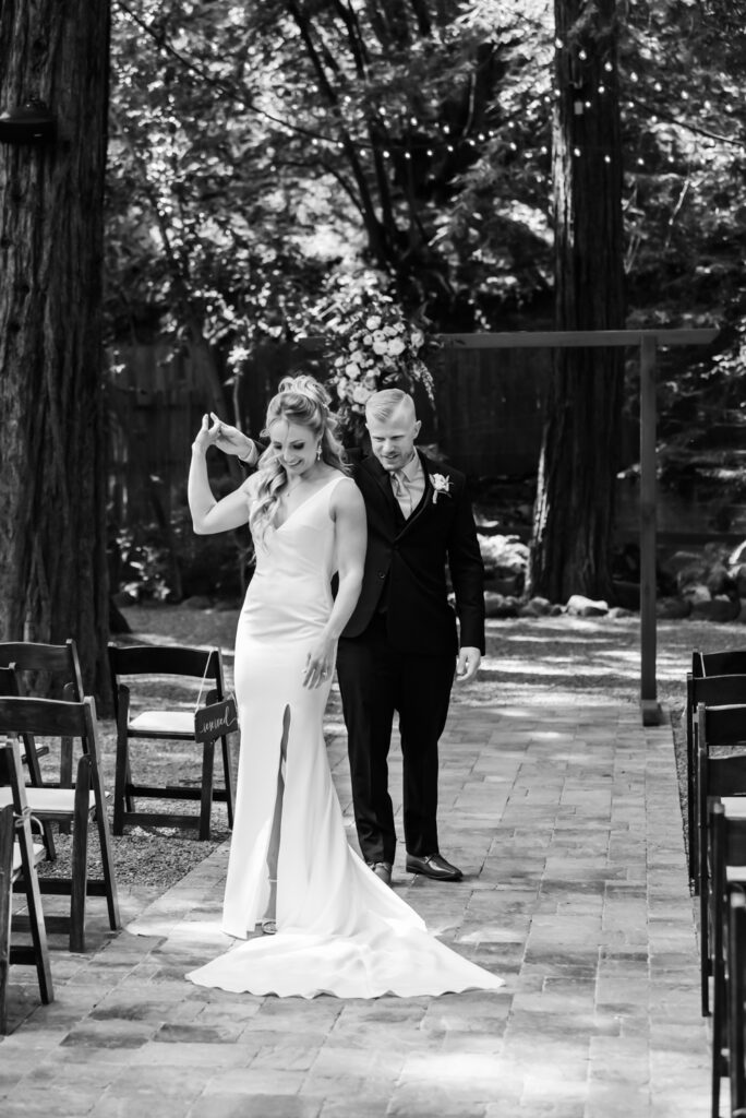 Black and white image of Bride and Groom dancing outside the wedding venue.