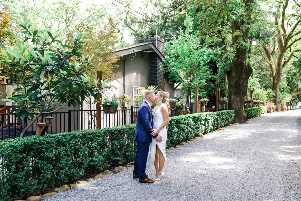 Bride and groom share kiss outside of Deer Park Villa wedding venue.