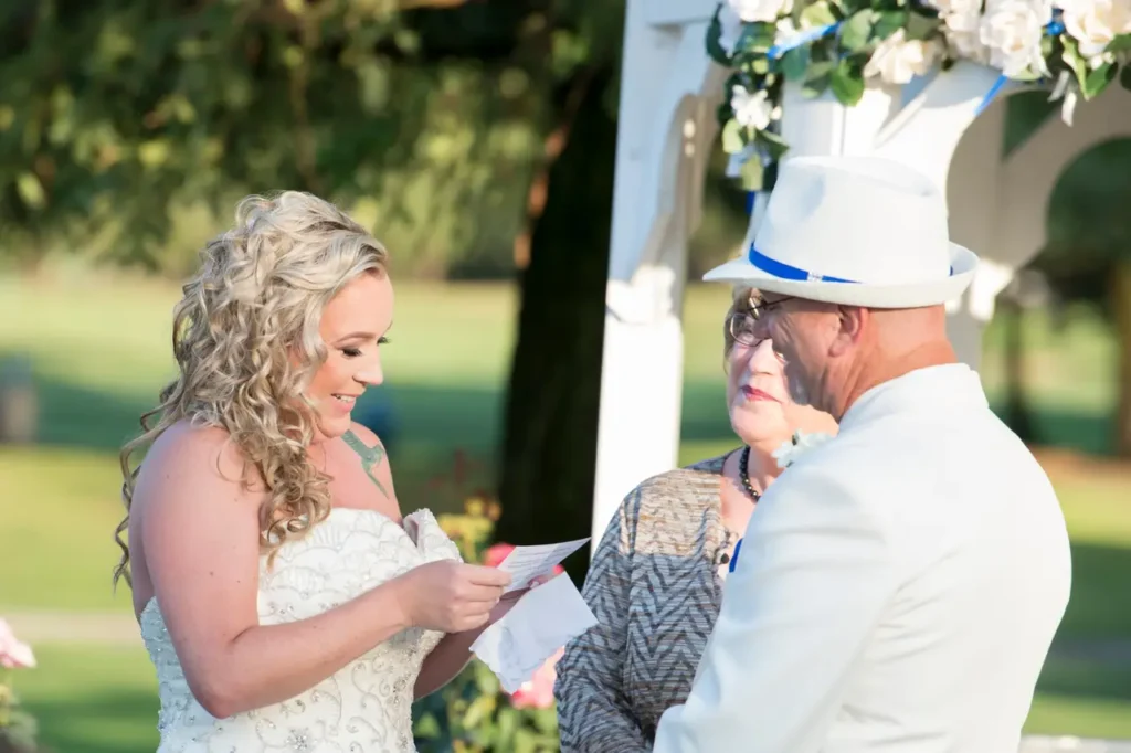 How to choose a wedding photographer, bride reading her vows to the groom on a summer day. 