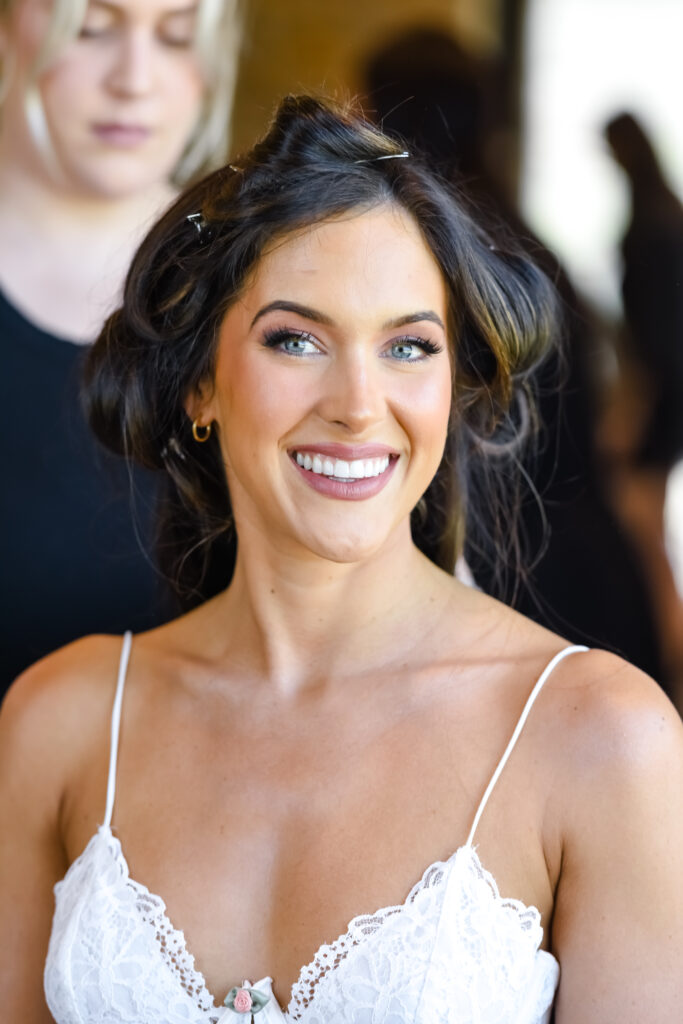Smiling bride in hair and makeup at Stanly Ranch wedding venue in Napa Valley. 