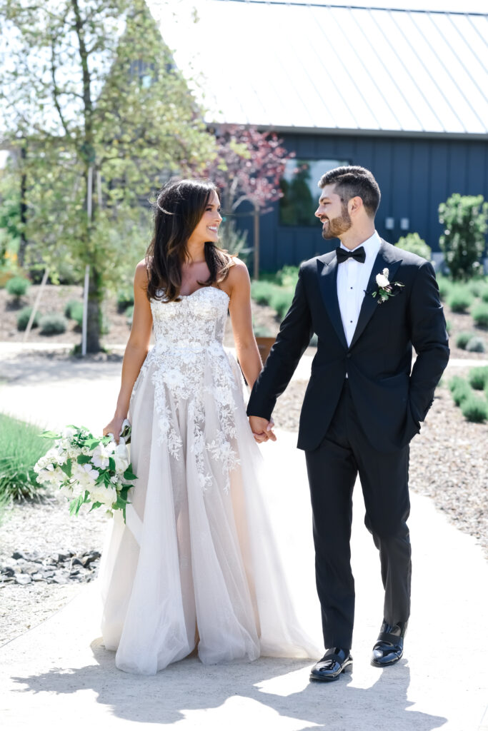 Bride and groom walk through gardens at Stanly Ranch wedding venue in Napa Valley. 