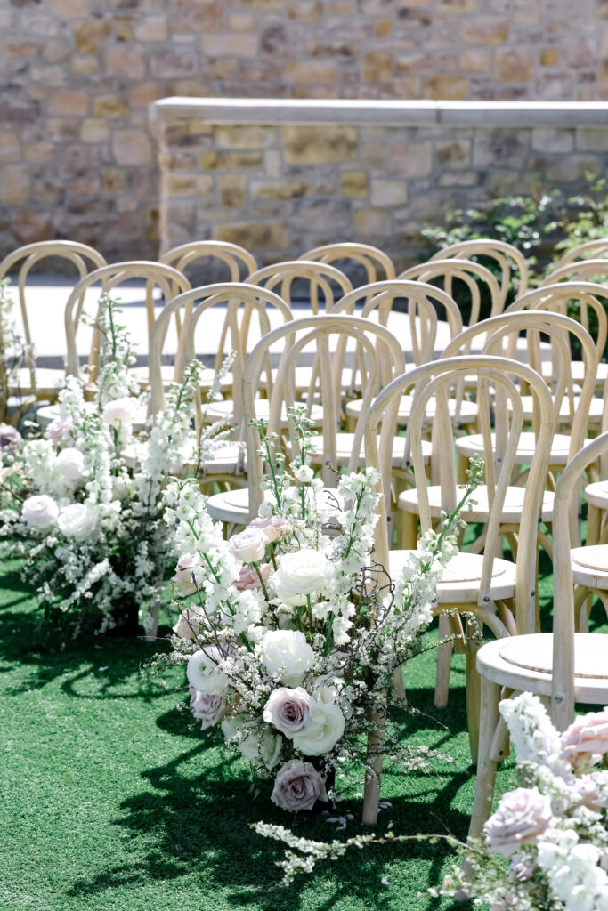 Rustic wedding ceremony chairs and flowers at Stanly Ranch wedding venue in Napa Valley. 