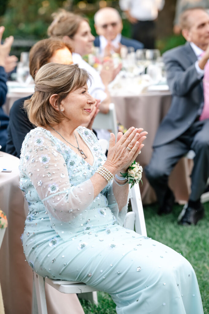 Mother of the bride claps at wedding at Vine Hill House in Sebastopol.