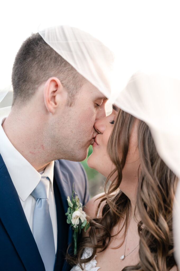 Romantic veil kiss at deLorimier Winery Wedding Venue in Sonoma County.