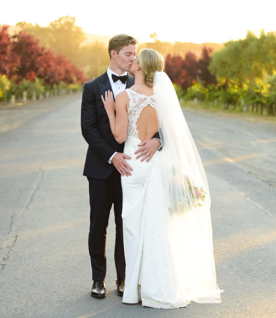 How to choose a wedding photographer. Wedding couple in wine country with autumn tress in the background. 