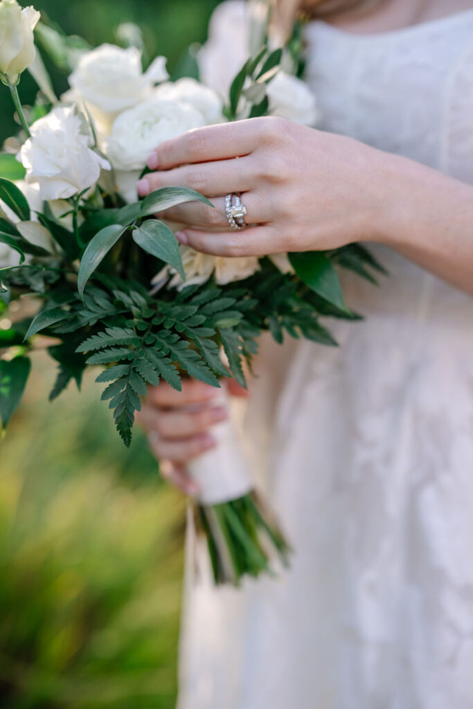 Close up of flowers and ring on bride's finger