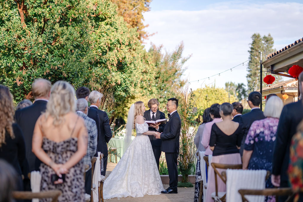 Plan a Backyard Wedding at a Private Residence, photo of bride and groom exchanging vows.