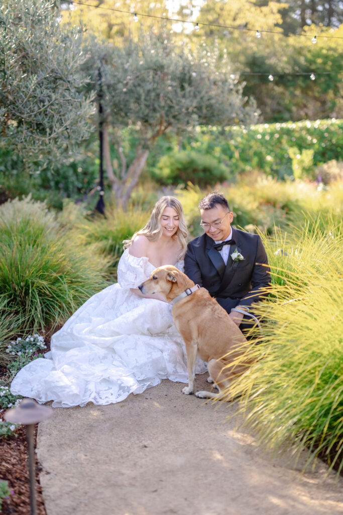 Plan a backyard wedding and be able to include your dog. Photo of bride and groom with dog.