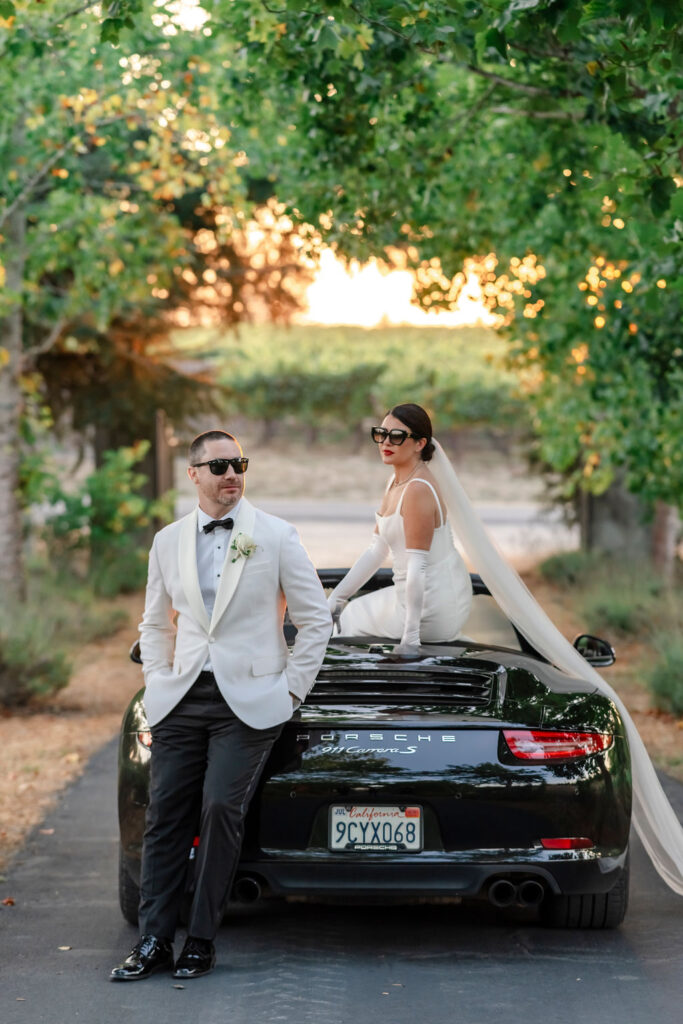Sonoma Vine Hill House. Damo and Sorcha on a car framed by the vineyard vines. 