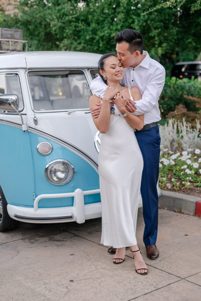 Engaged couple embracing beside a vintage car during a San Francisco proposal at the Lodge of Sonoma, sharing a quiet moment after saying yes.