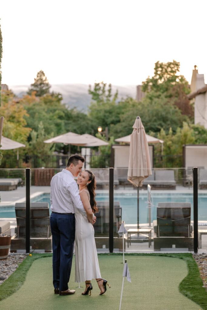 Newly engaged couple standing together near the pool at a San Francisco proposal location at the lodge of Sonoma, sharing a quiet moment after their engagement.