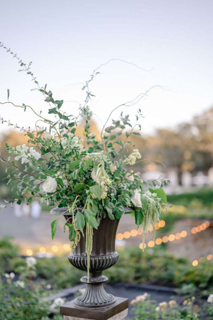 Elegant white and green floral arrangement in a stone urn on the terrace at Montage Healdsburg wedding venue