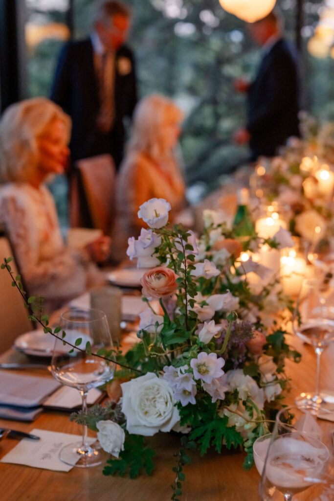 Intimate wedding reception table at Montage Healdsburg with candlelight, soft floral arrangements, and guests gathered for dinner.