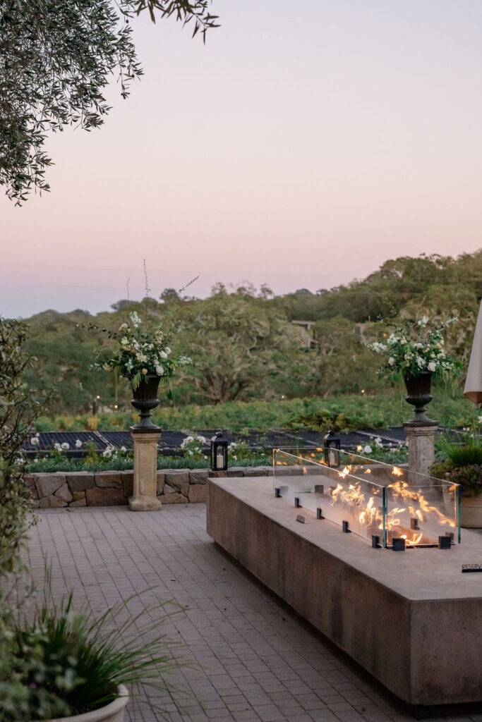 Outdoor terrace with fire pit overlooking vineyards at Montage Healdsburg during golden hour