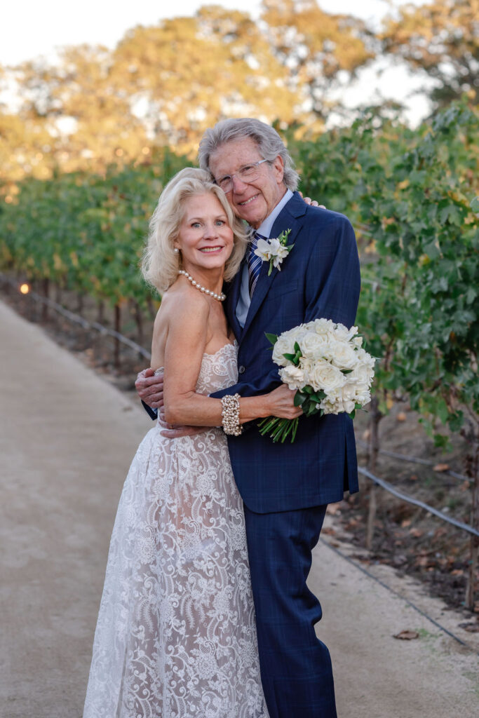 Bride and groom laughing together between vineyard rows at Montage Healdsburg