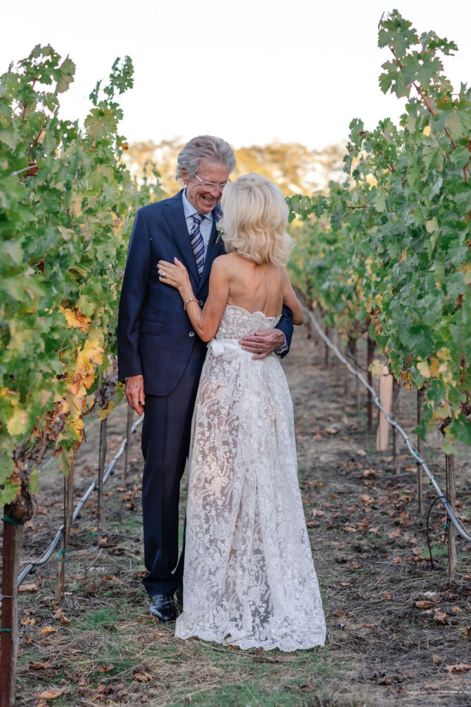 Bride and groom standing together in a vineyard at golden hour at Montage Healdsburg