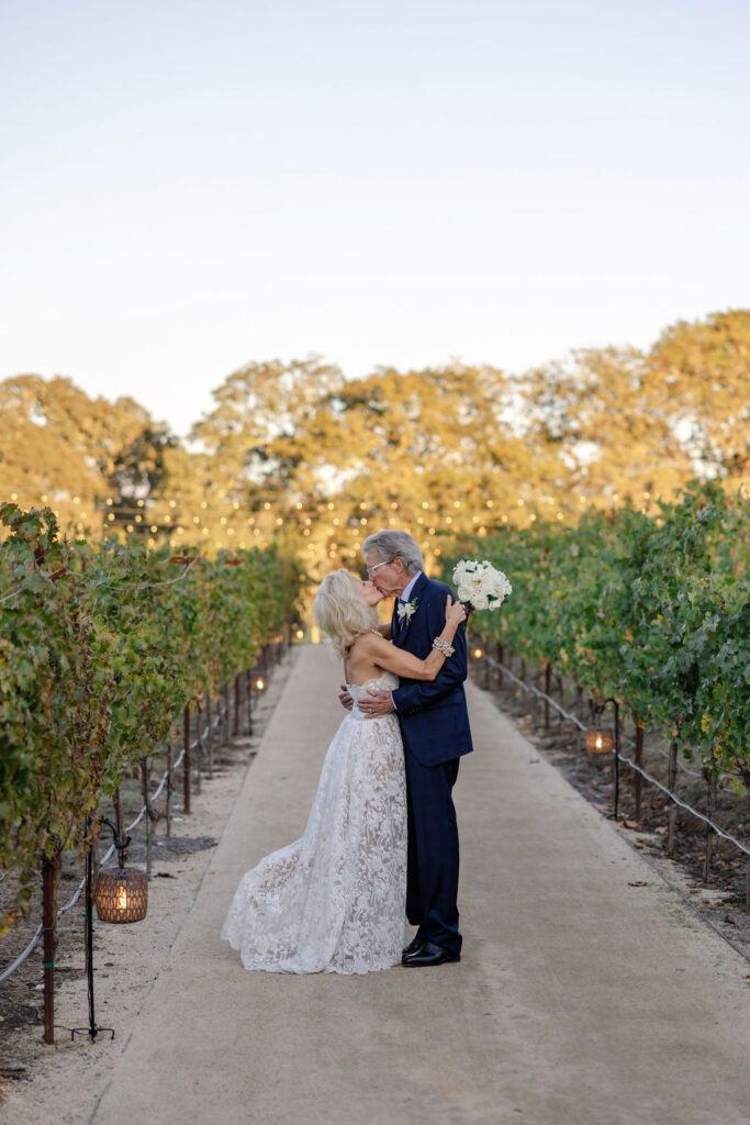 Bride and groom embracing among the vineyard rows at Montage Healdsburg
