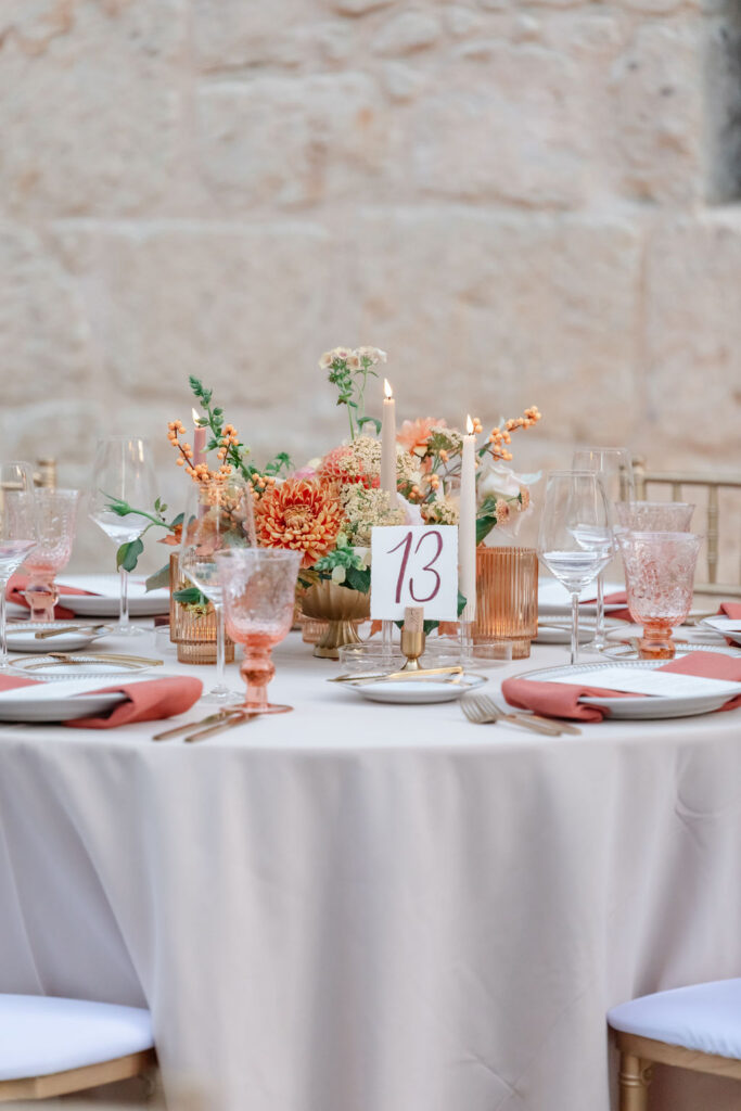 Elegant reception table with peach linens, floral centerpiece, and gold flatware at a Buena Vista Winery wedding in Sonoma.