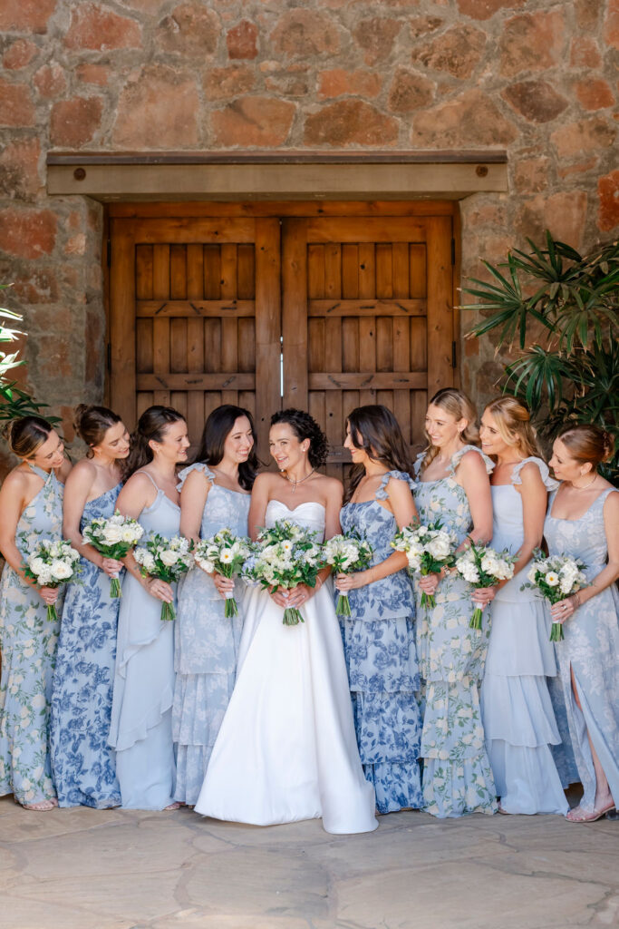 Bride with bridesmaids in blue dresses during wedding portraits at Mayacama Golf Club in Sonoma.