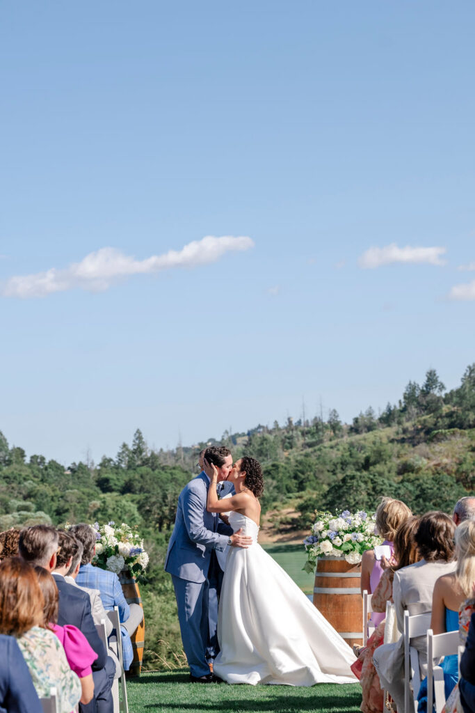 First kiss at Mayacama Golf Club wedding ceremony overlooking Sonoma hills