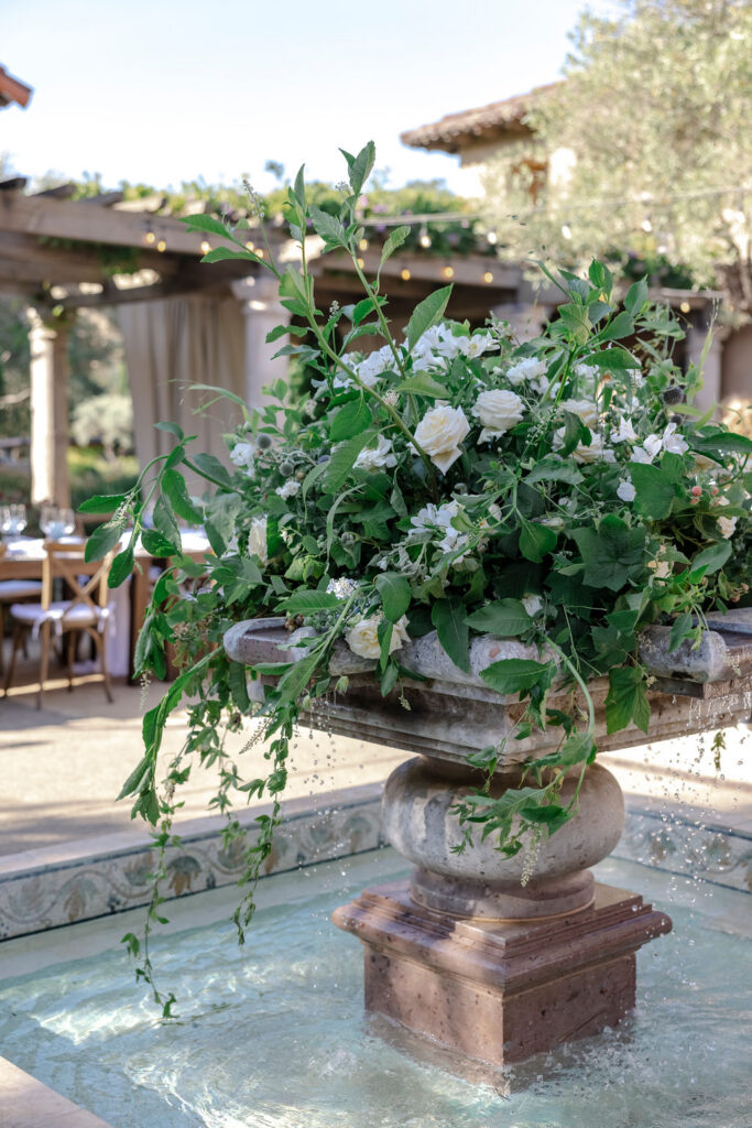 Stone fountain with lush greenery centerpiece at Mayacama Golf Club wedding venue in Sonoma