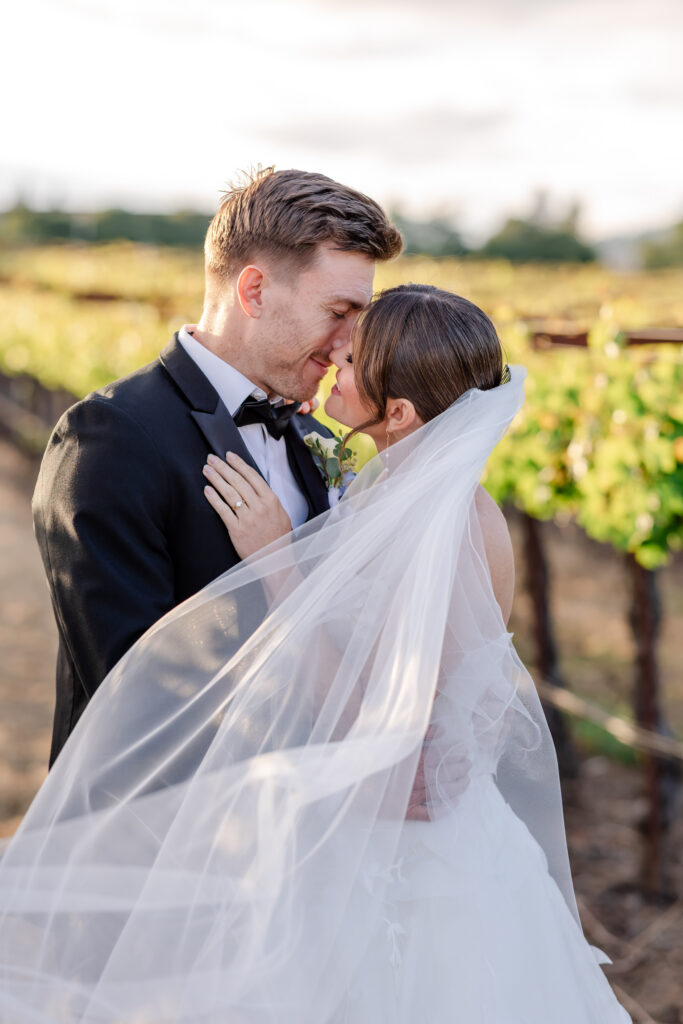 Bride and groom golden hour portrait in the Napa Valley vineyard rows, photographed by Alicia Parks Photography